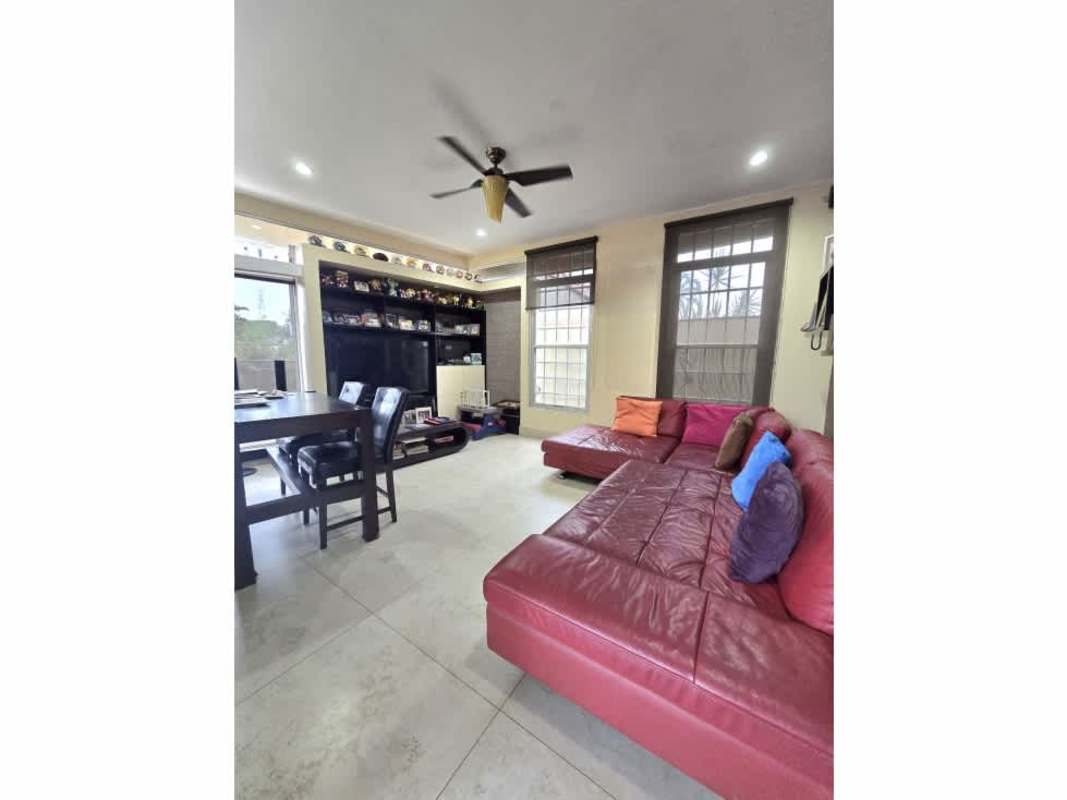 Spacious covered terrace with dining table and seating in Altos de Panamá house