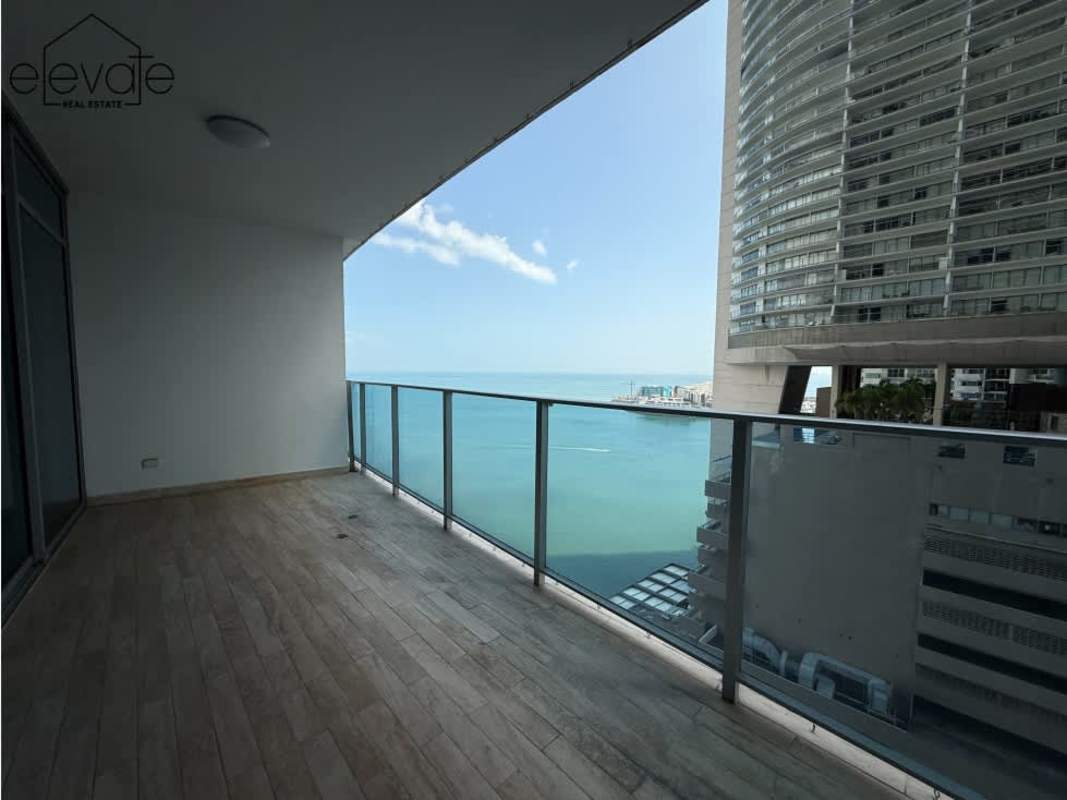Bedroom with large windows offering sea and skyline views in Grand Tower Panama