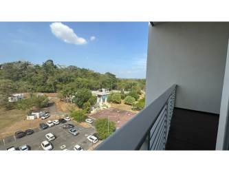 Balcony overlooking parking lot with trees at PH Mosaic Panama Pacifico