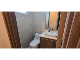 Modern bathroom with glass shower enclosure in Bosques del Pacífico house