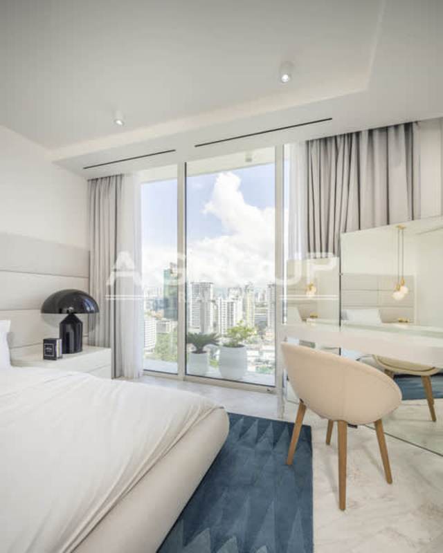 Luxury bedroom suite with walk-in closet and floor-to-ceiling windows ocean views Marbella Panama