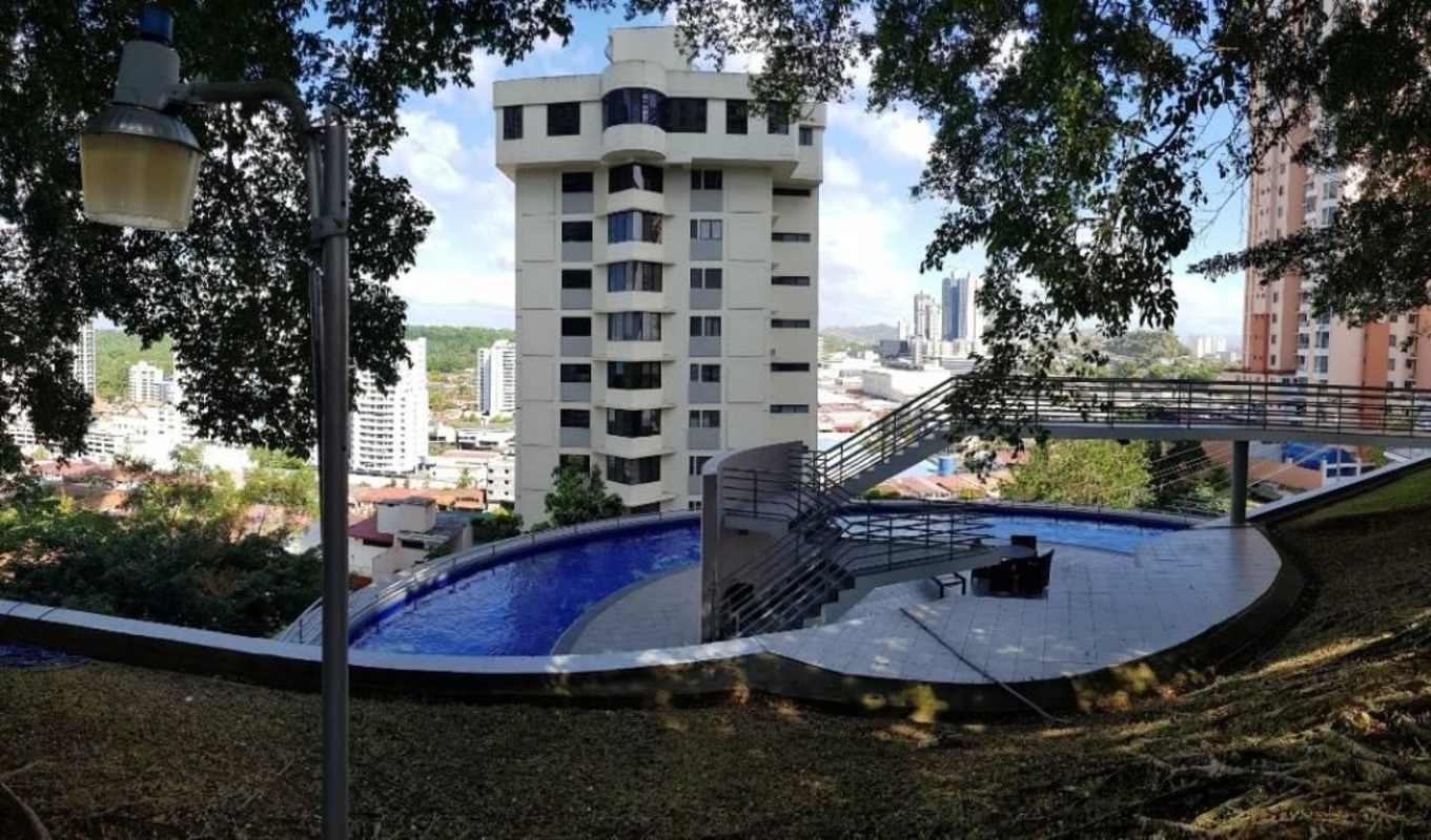 Curved infinity pool with walkway overlooking Panama City skyline at Elite 100 Dos Mares
