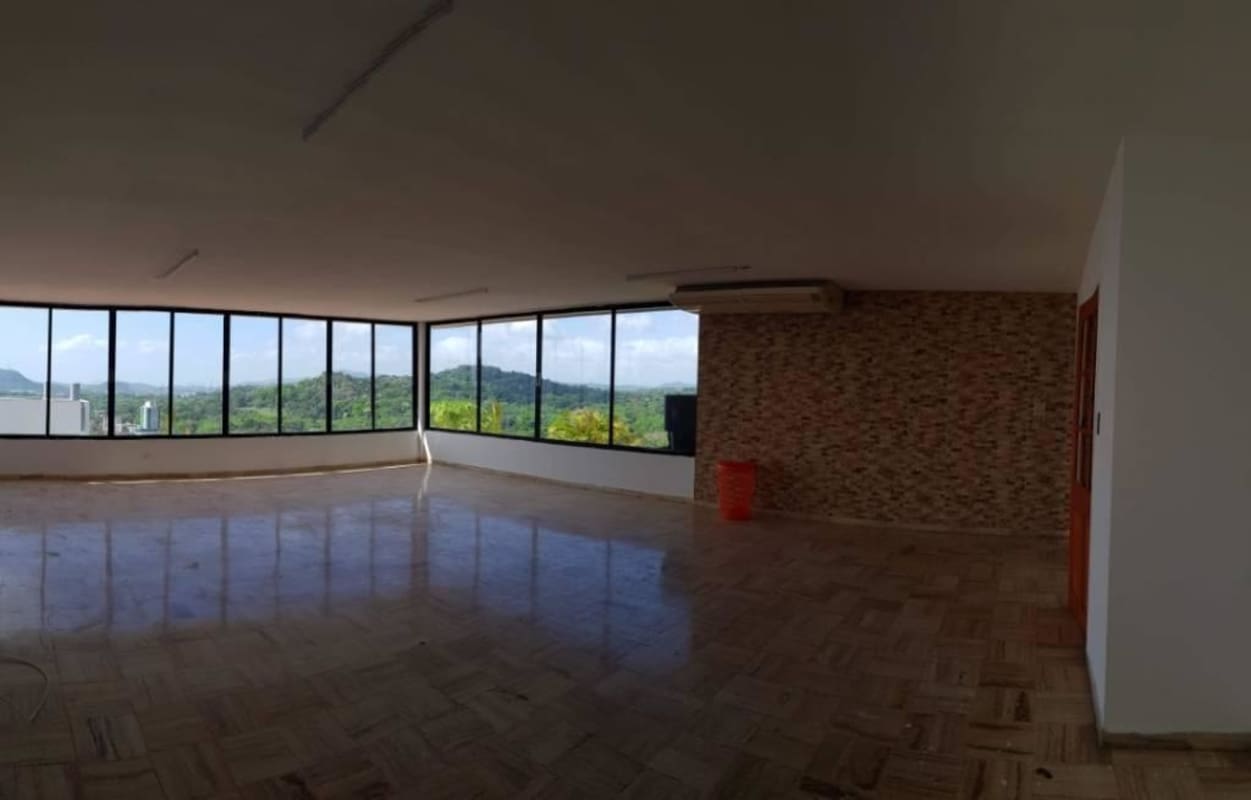 Large living room with floor-to-ceiling corner windows offering mountain views PH Elite 100 Dos Mares Panama City