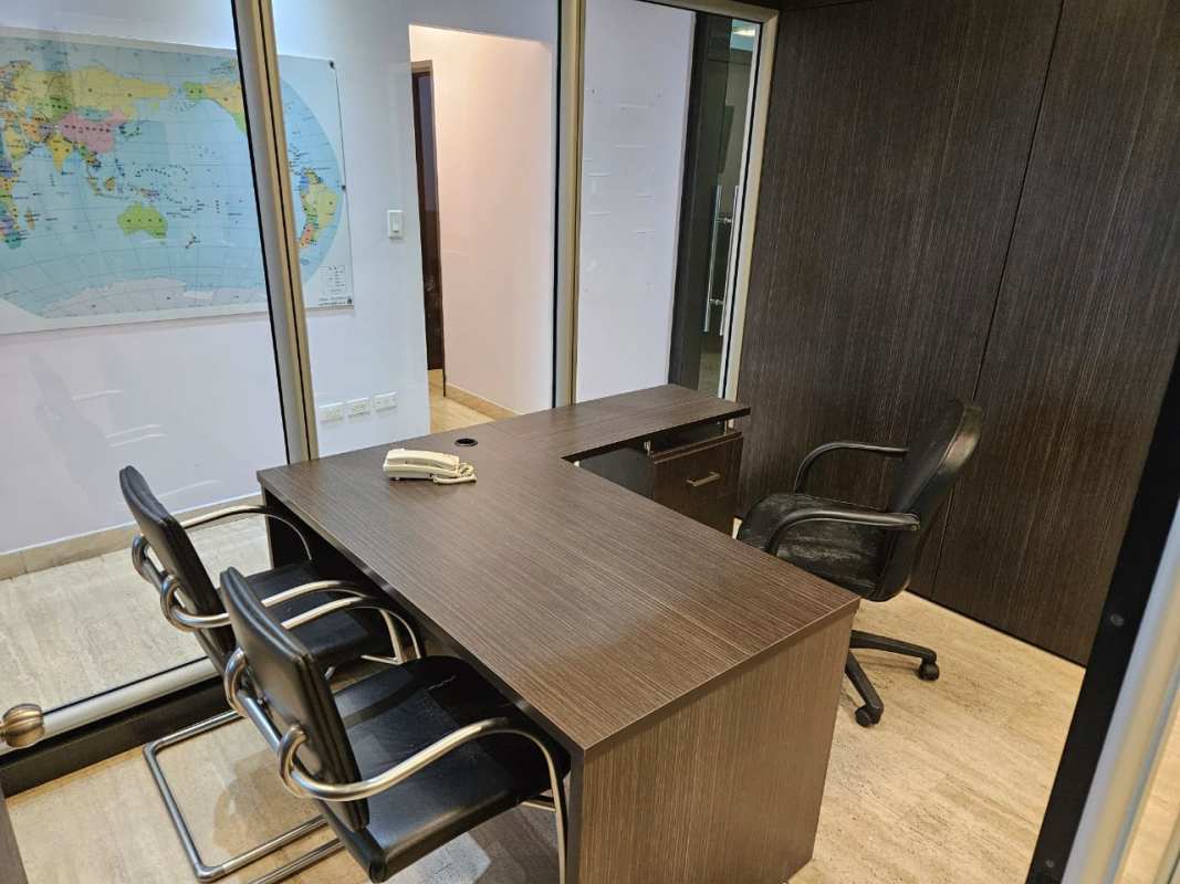 Glass wall enclosed private workspace with desk and world map decoration Punta Pacifica