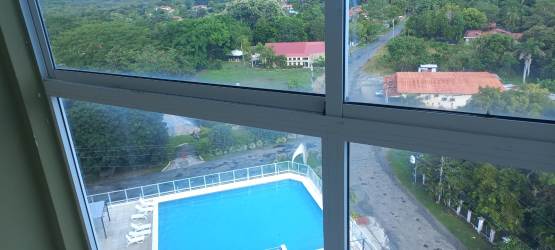 Large window with seaside and pool views in studio apartment Ibiza Condo Hotel Coronado Panama