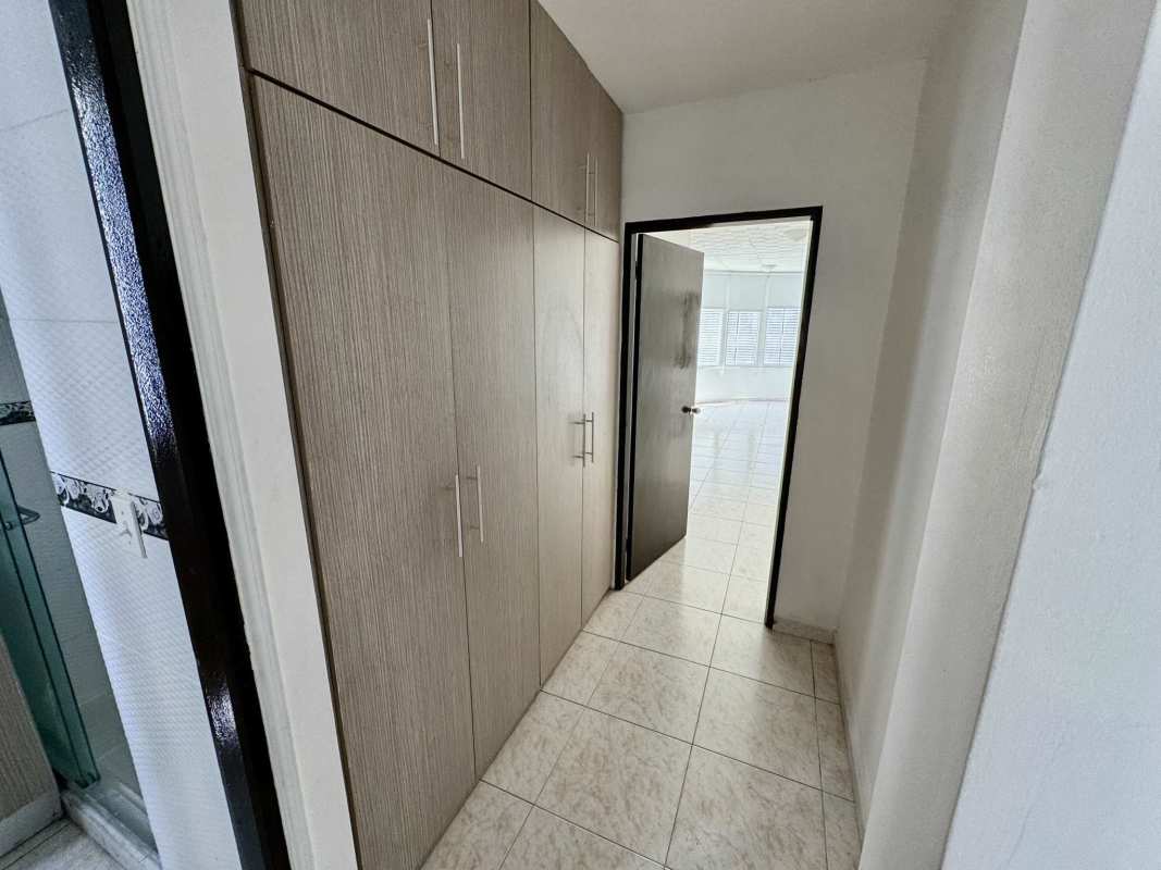 Modern bathroom with granite sink vanity and walk-in shower in PH Deveaux San Francisco Panama apartment