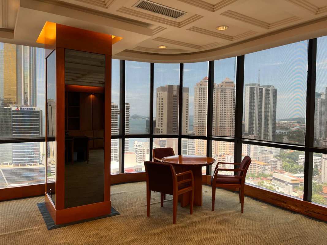 Modern reception lobby with granite counter and wood panelling at PH BICSA Tower