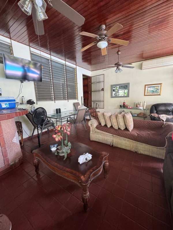 Large living room with wood ceiling and granite floor in San Francisco single-family house Panama City