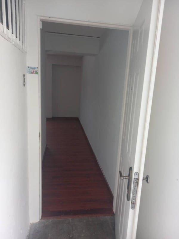 Living room with laminate flooring, AC unit, white walls apartment Parque Lefevre Panama City