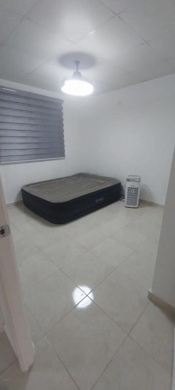 Minimalist empty bedroom with tiled floor and wardrobe in Cumbres del Lago Panama City