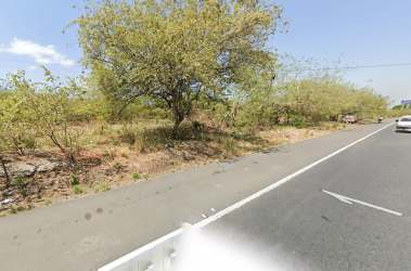 Street view of commercial land lot with sparse vegetation along Pan-American Highway Rio Hato Panama