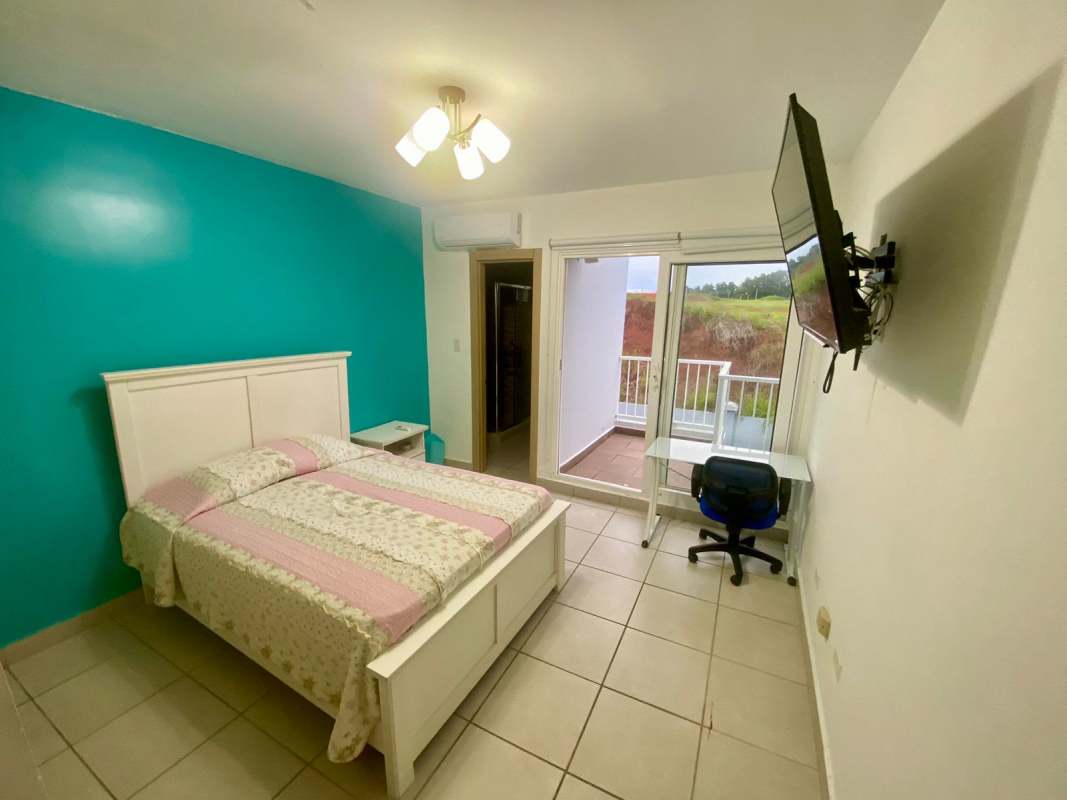 Kitchen with wooden cabinets and tiled backsplash in duplex house PH Victoria Panama