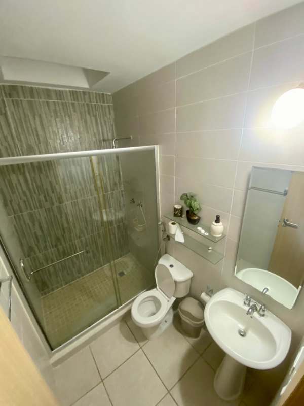 Contemporary bathroom with glass enclosed shower and modern fixtures in PH Victoria Brisas del Golf Panama
