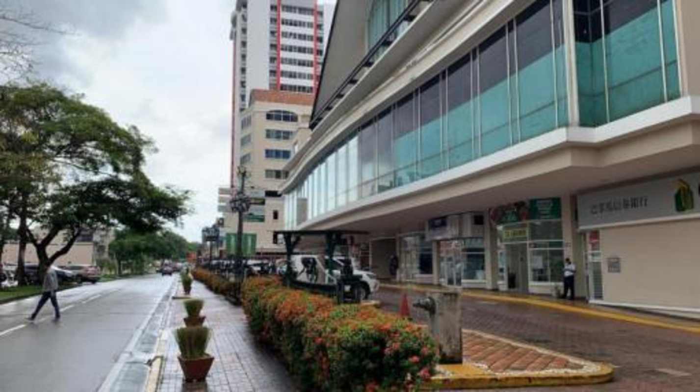 Street view of Plaza Camino de Cruces commercial plaza with parked cars and stores El Dorado Panama