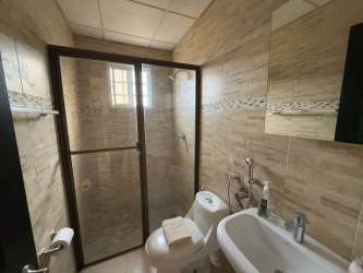 Large closet with shelves, hanging rods and ceiling fan light in Herrera Panama house