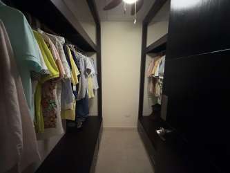 Modern kitchen with dark cabinets, granite top, stainless appliances in Herrera Panama home