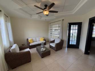 Exterior garden with tiled patio and stucco walls at Brisas del Sur house Chitré Panama