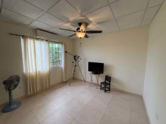 Contemporary kitchen with granite countertops, appliances, and dark cabinets in Chitré house
