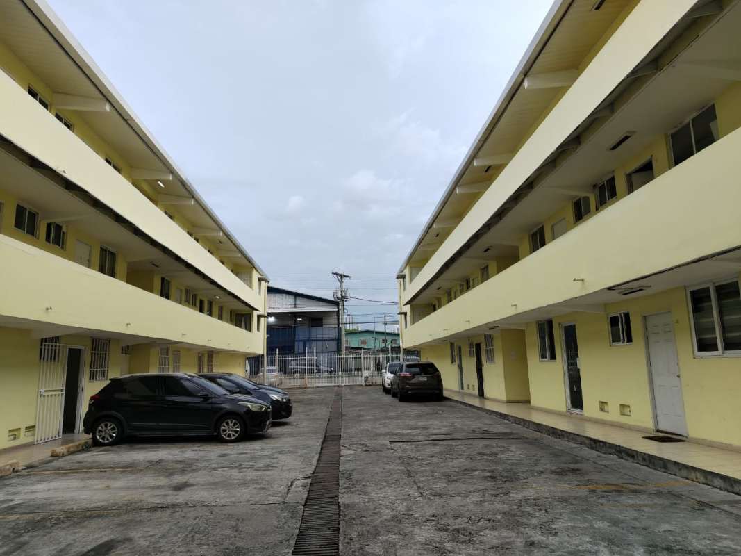 Gated entrance of PH Montserrat apartment complex with yellow facade in Panama City