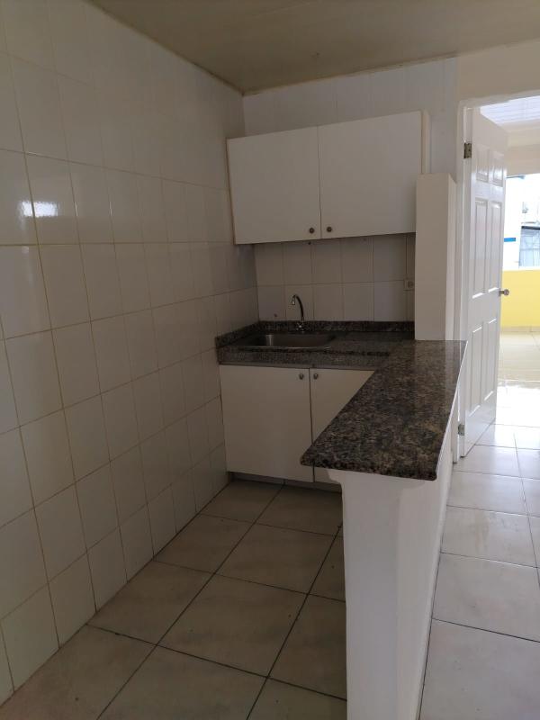 Simple kitchen with granite countertop and white cabinets at PH Montserrat Rio Abajo Panama City