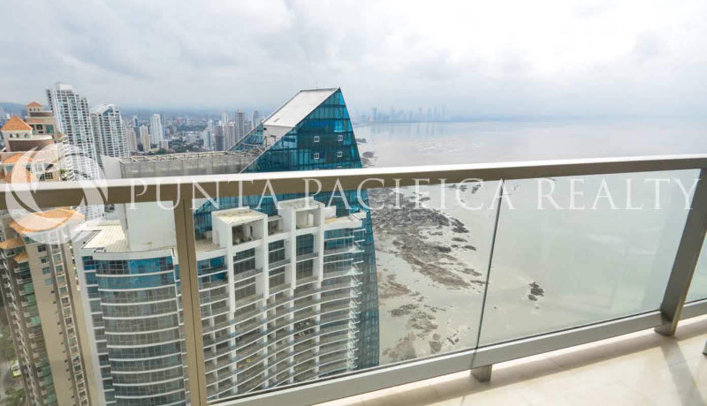Elegant living room with floor-to-ceiling windows and ocean views in luxury condo at The Ocean Club Punta Pacifica