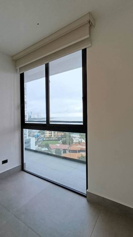 Spacious living room with large sliding doors to balcony, ocean and skyline view in PH Victory Wellness Panama