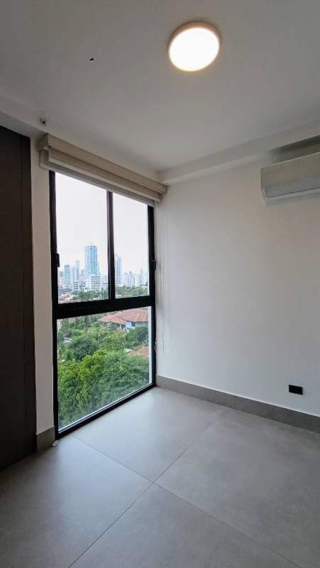 Bedroom with large windows and city view at PH Victory Wellness Panama City