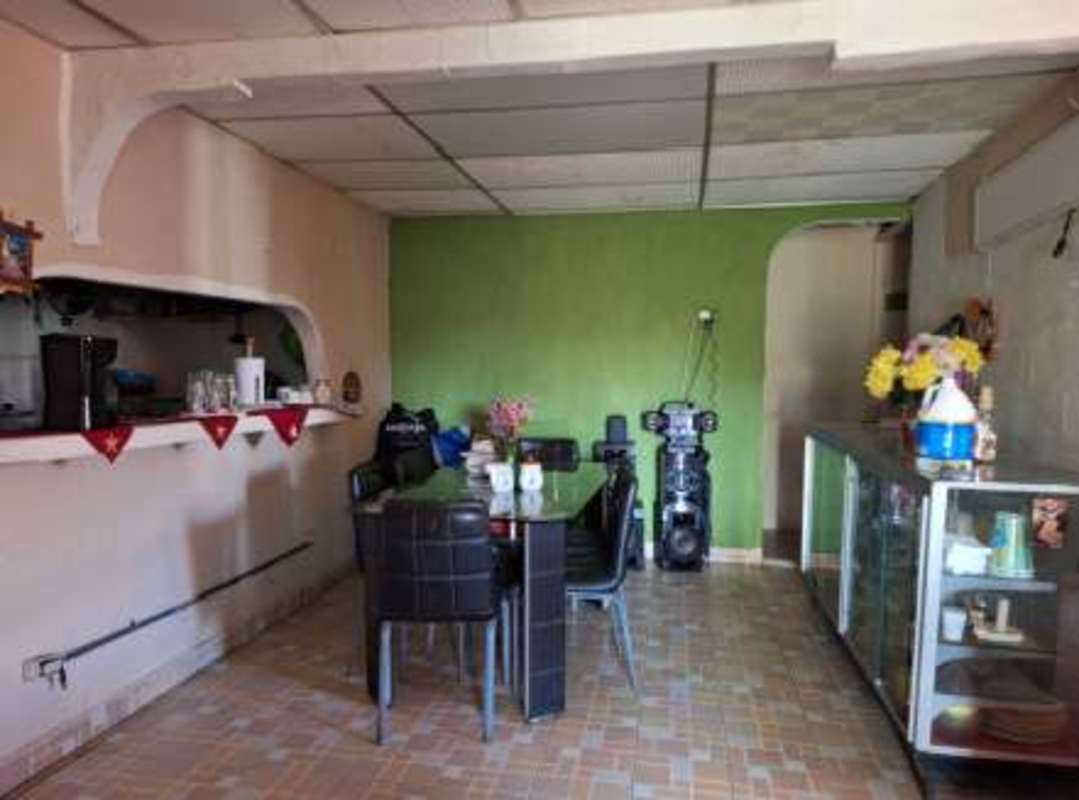 Open dining room with green accent wall and tile floor Panama home