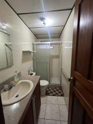 Modern bathroom with glass shower enclosure and vanity in La Arboleda home for sale