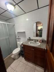 Bathroom featuring glass door shower, granite countertop vanity in home for sale Panama Oeste