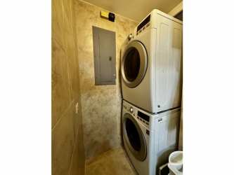 Laundry room with modern washer/dryer at Tucan Country Club apartment Panama