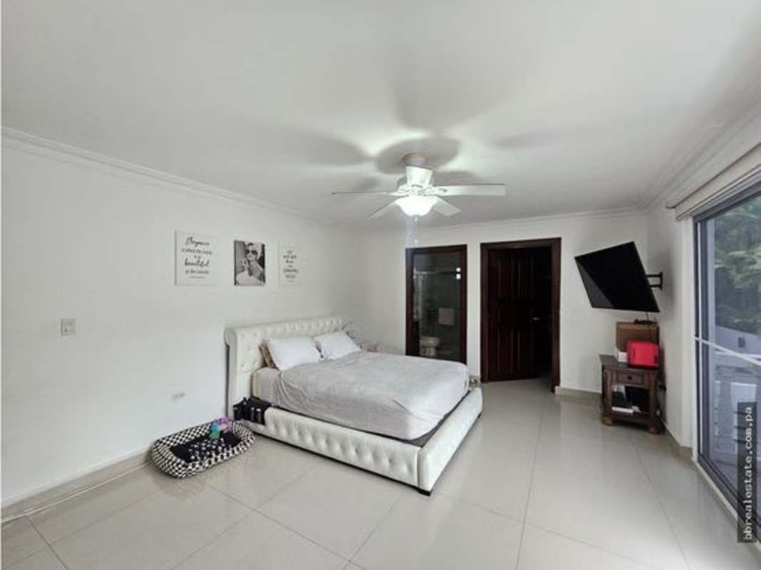 Formal dining room with chandelier, large dining table, and open layout luxury home Altos del Golf Panama