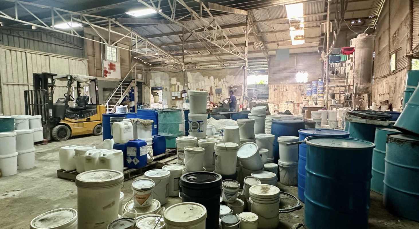 Large open warehouse area with barrels, containers, forklift in Panama