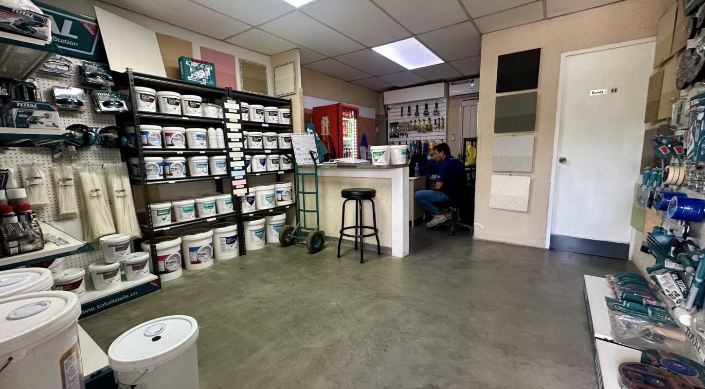 Hardware shop interior with counter, shelving, paint products in Zona Franca Chilibre