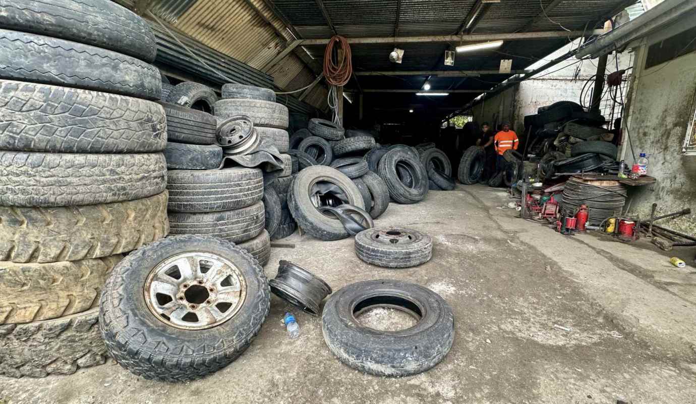 Industrial garage filled with used tires and workbenches Panama