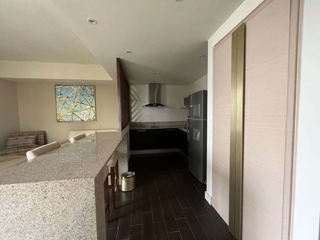 Contemporary open kitchen with granite counters and appliances in PH Waldorf Astoria Marbella Panama