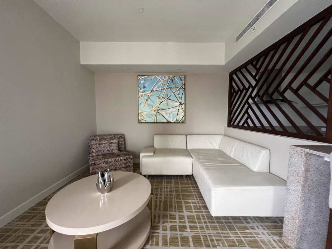 Spacious bedroom with king-sized bed, city skyline views, marble floors PH Waldorf Astoria Panama City