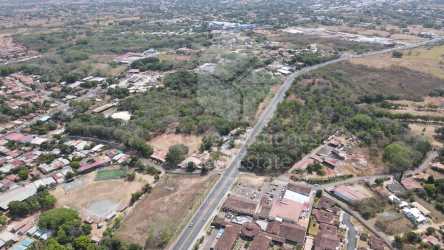 Aerial city view featuring large land plot, nearby malls and main avenue in Chitré Panama