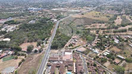 Panoramic aerial revealing surrounding cityscape and road access near Hotel Cubita Chitré