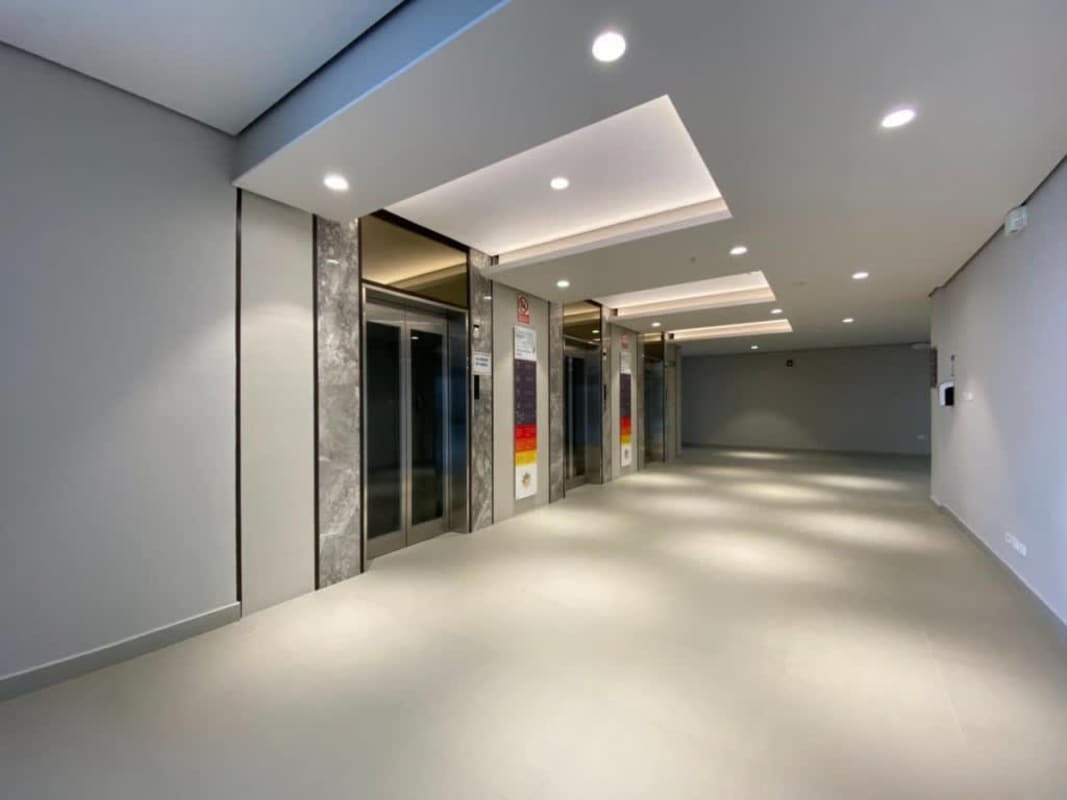 Minimalist lobby elevator zone with marble accents and recessed lighting in Costa del Este Panama