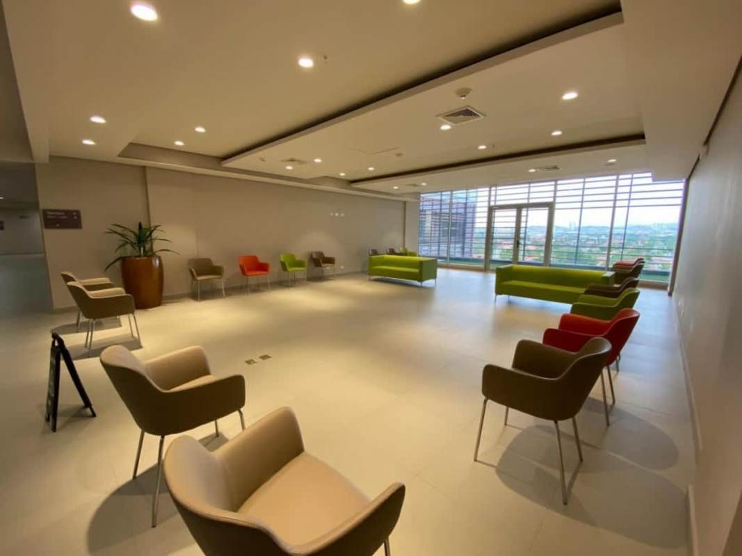 Modern minimalist lobby with benches, planters and security camera at Torre Costa Medical Center Panama