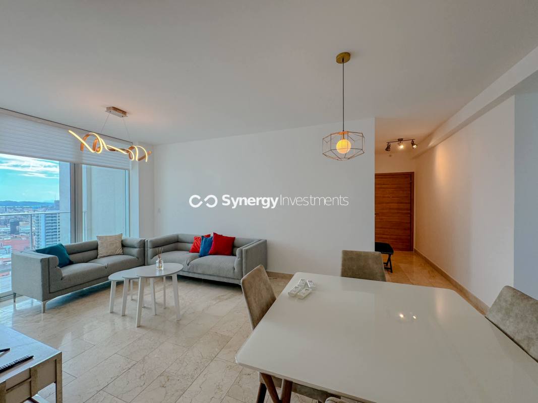 Open concept living dining room with floor to ceiling windows city skyline Dynasty Residences Panama City