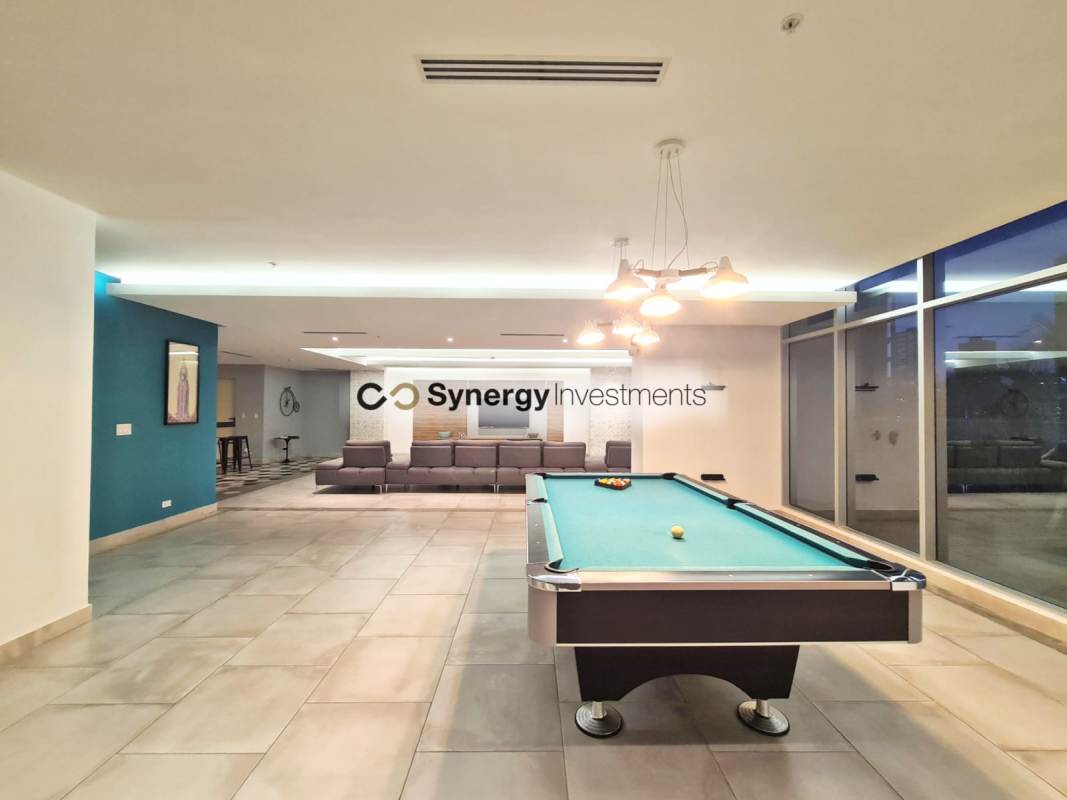 Modern lounge and pool table area with large windows city views Dynasty Residences Panama City