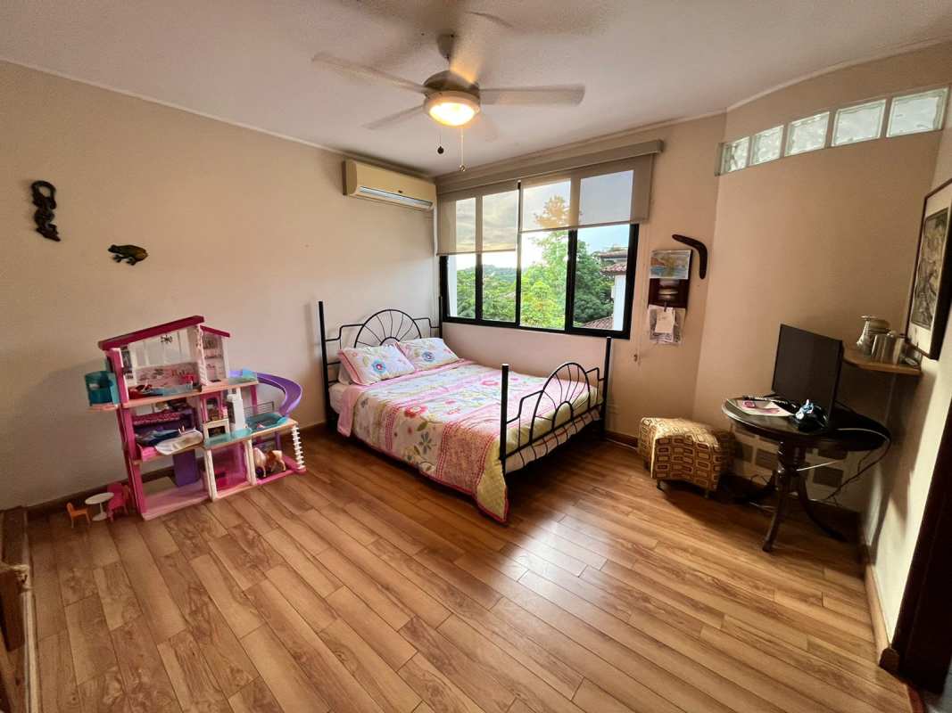 Bedroom with wooden floors, split AC, fan, closet in Dos Mares luxury family house Panama