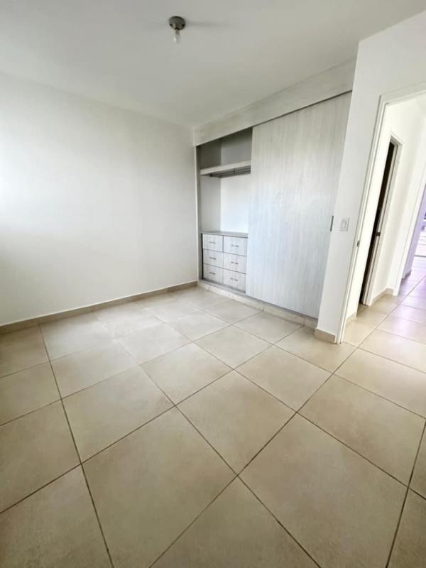 Spacious living room with modern decor, large windows, and tall ceiling in Villasur Residences Costa Sur Panama