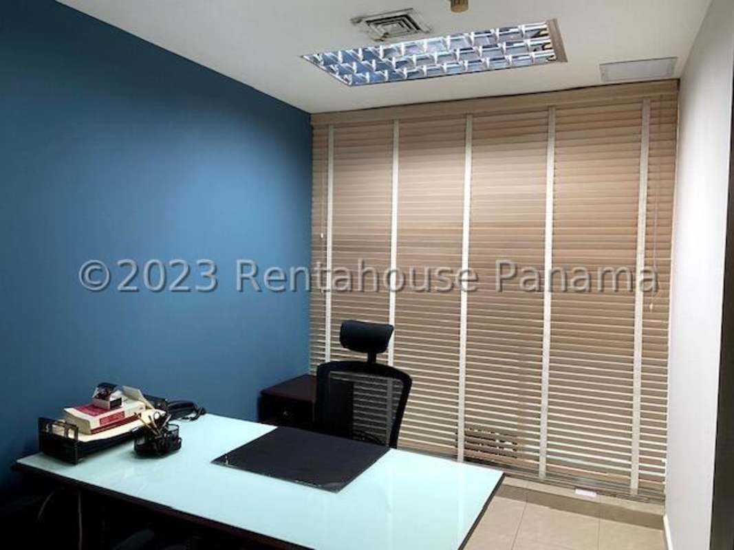 Reception area with dark wooden desk, lighting, minimalist decor in PH Bella Vista Tower Panama