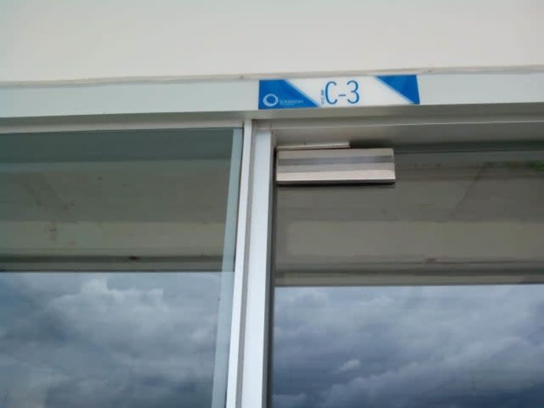 Glass sliding door with electronic lock at Terrazas de Albrook commercial plaza