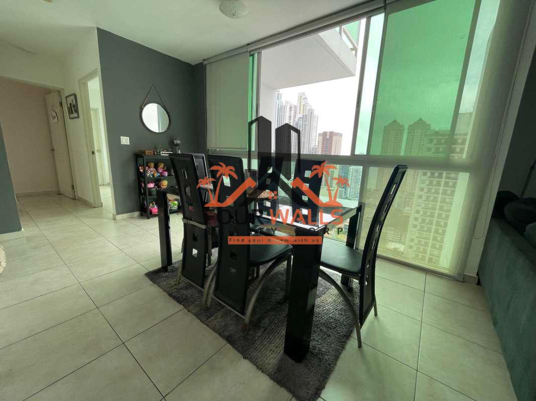 Open concept living and dining area with large windows and city skyline in PH The Seawaves