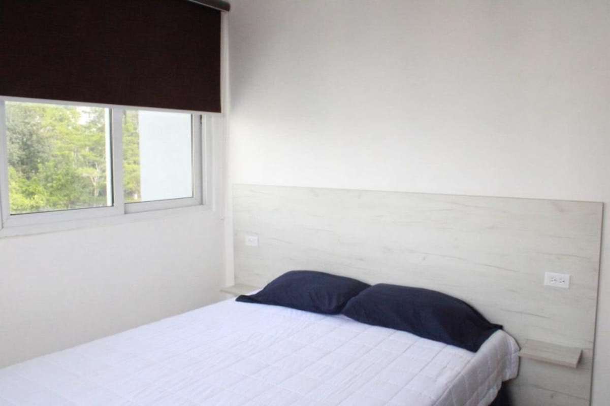 Bedroom setup with large window blackout blinds flat TV PH Urbis Tower Edison Park Panama