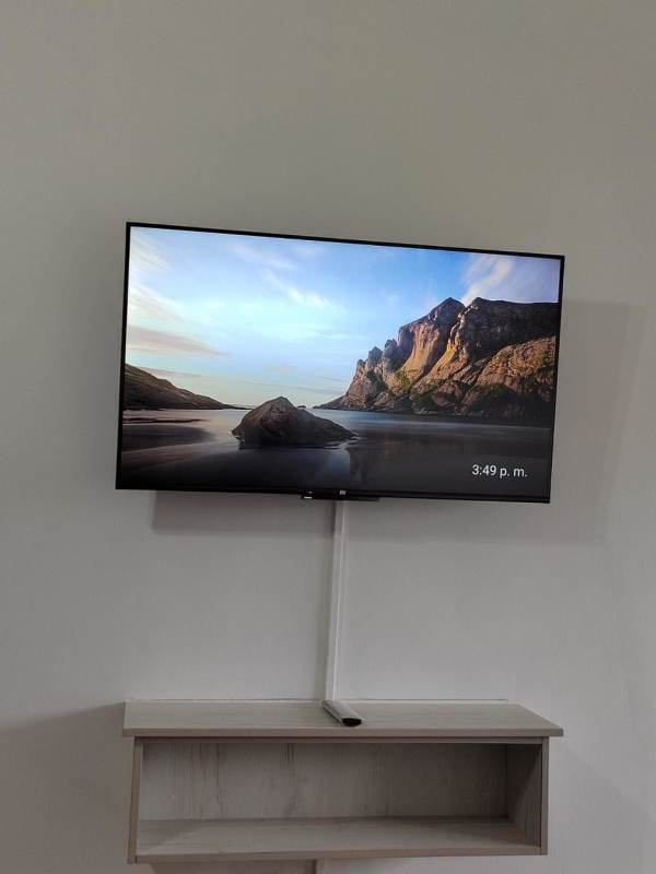 Floating wooden shelf with mounted TV minimalist setup PH Urbis Tower Panama